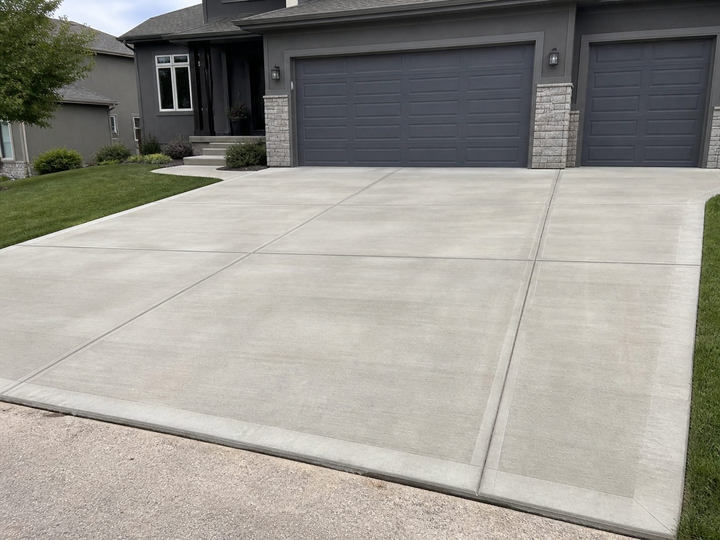 Concrete outdoor area adjacent to a residential pool showing finished slab quality